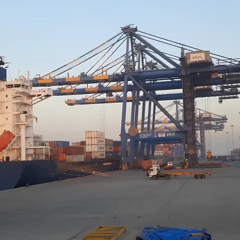 Ship-to-shore cranes and a container vessel alongside at Dahej