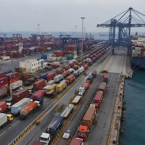 Container trailers queuing beside a berthed vessel at Nhava Sheva (JNPA)